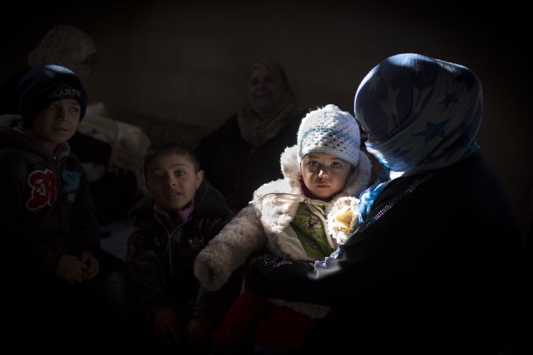A refugee mother holds her baby