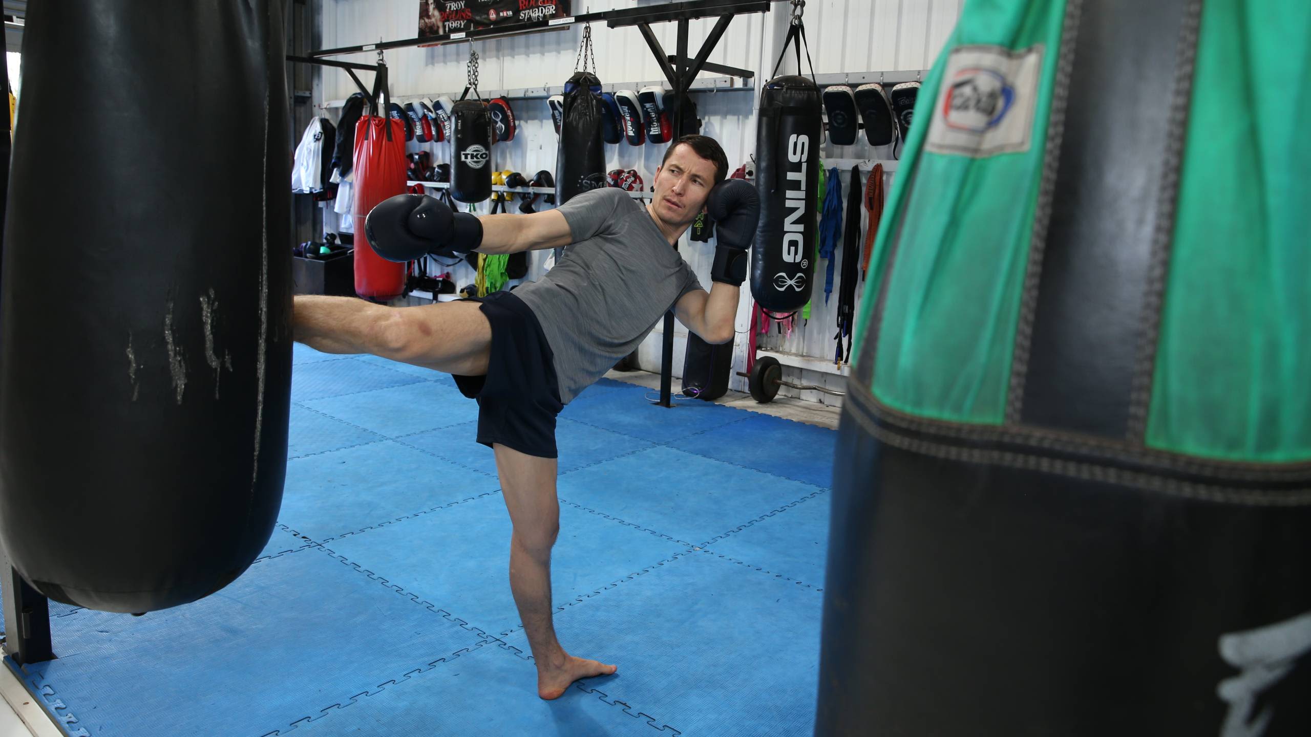 Asif Sultani kicks a bag in the dojo.