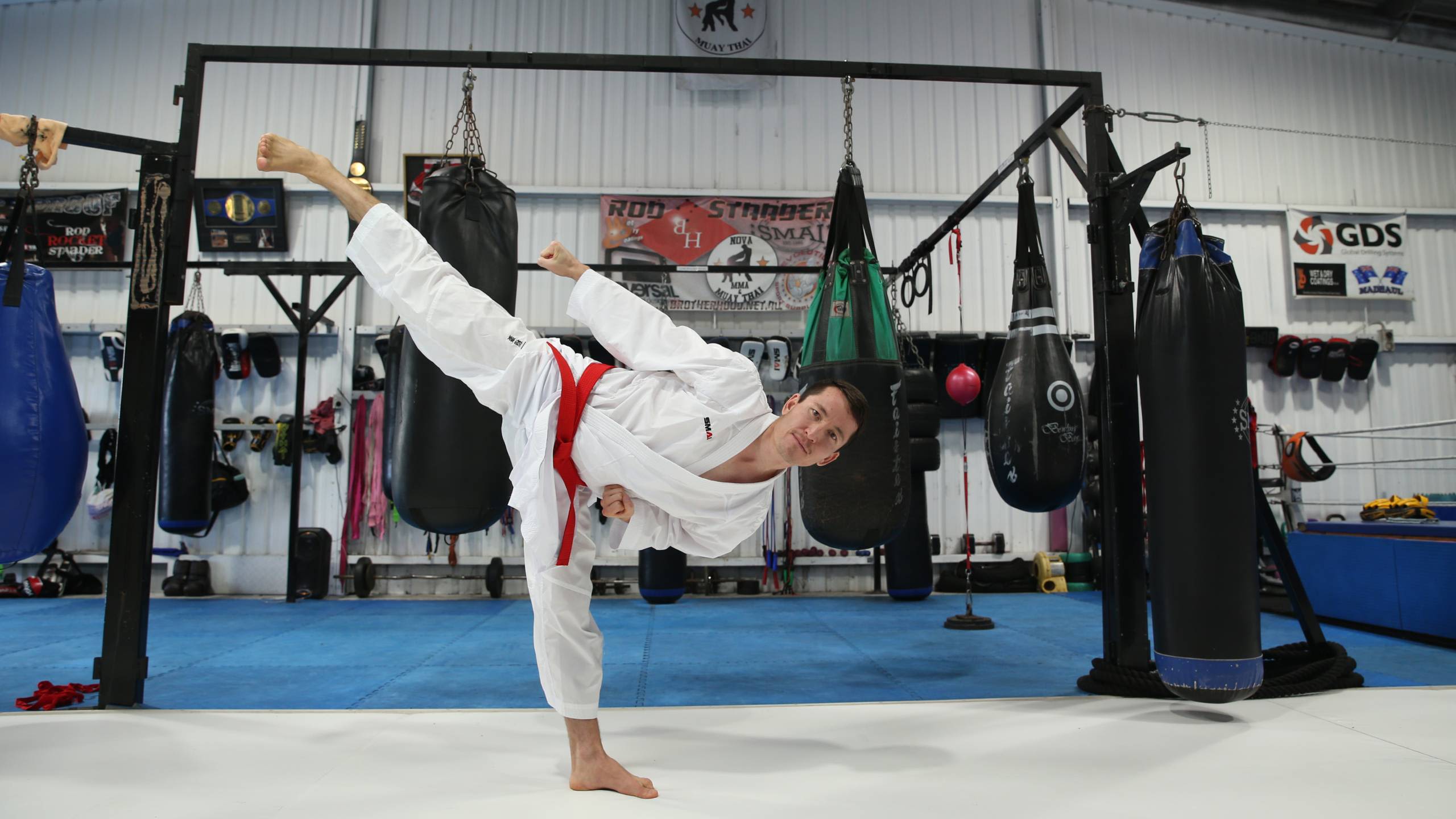 Asif Sultani performs a kick in the dojo.