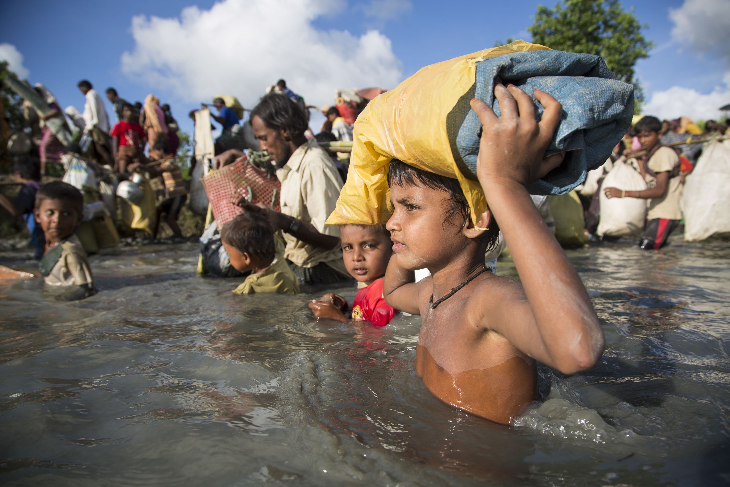A Rohingya boy flees across the border into Bangaldesh